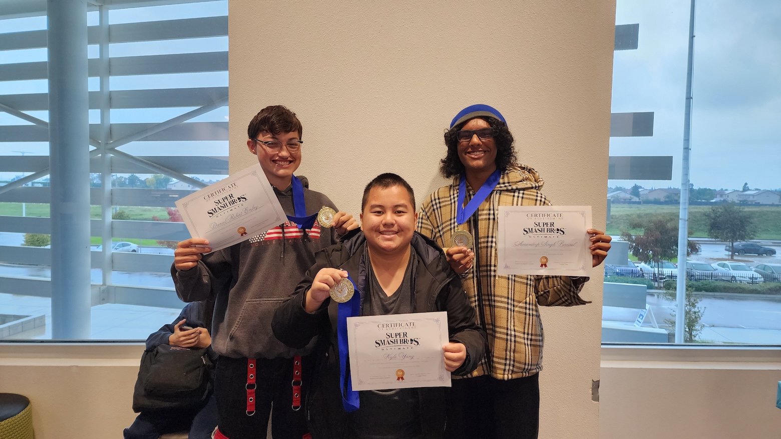 The winning Super Smash Bros. team poses with their medals